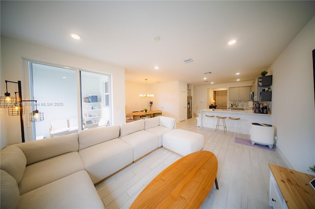 138 SW 171st Way, Pembroke Pines, FL 33027 - living area with a chandelier, light wood-style flooring, and recessed lighting