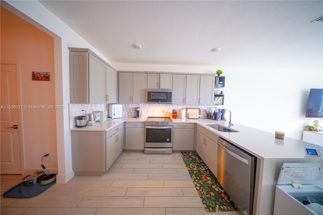138 SW 171st Way, Pembroke Pines, FL 33027 - kitchen with stainless steel appliances, gray cabinets, light countertops, open shelves, and backsplash