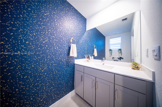 138 SW 171st Way, Pembroke Pines, FL 33027 - bathroom with wallpapered walls, vanity, and lofted ceiling