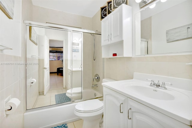 3511 Fairfax Dr, Fort Lauderdale, FL 33312 - bathroom featuring tile walls, tile patterned flooring, combined bath / shower with glass door, and vanity