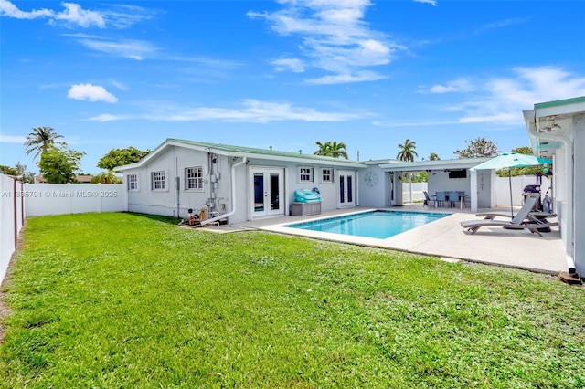 3511 Fairfax Dr, Fort Lauderdale, FL 33312 - rear view of house featuring french doors, a fenced backyard, and a patio area