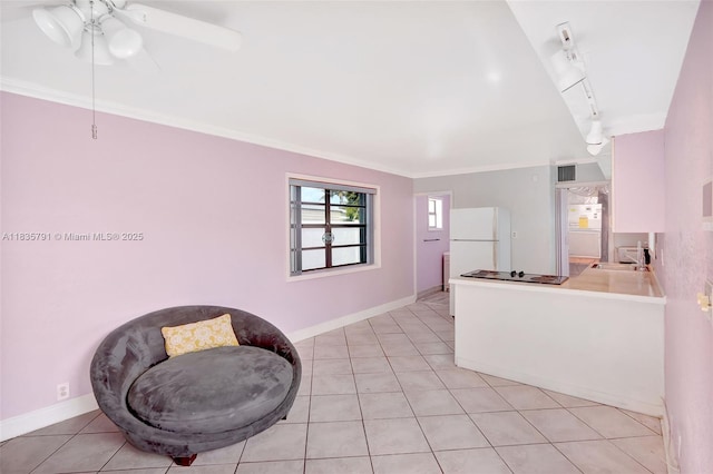 3511 Fairfax Dr, Fort Lauderdale, FL 33312 - kitchen featuring freestanding refrigerator, light tile patterned floors, a ceiling fan, ornamental molding, and light countertops