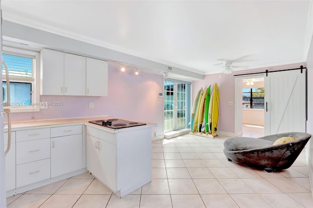 3511 Fairfax Dr, Fort Lauderdale, FL 33312 - kitchen with electric stovetop, a barn door, a peninsula, light countertops, and a ceiling fan