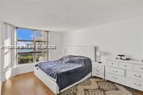 3400 NE 192nd St Unit 1403, Aventura, FL 33180 - bedroom featuring dark wood-type flooring