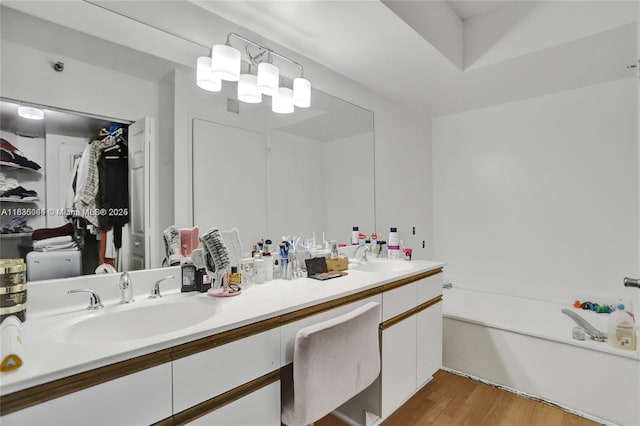 3400 NE 192nd St Unit 1403, Aventura, FL 33180 - bathroom with double vanity, wood finished floors, a bath, and a closet