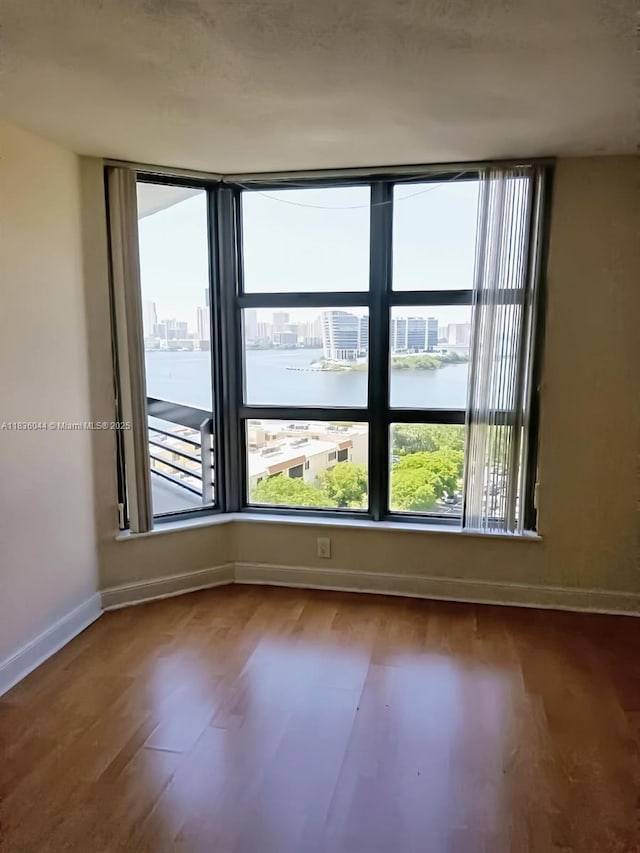 3400 NE 192nd St Unit 1403, Aventura, FL 33180 - spare room featuring wood finished floors and a water view