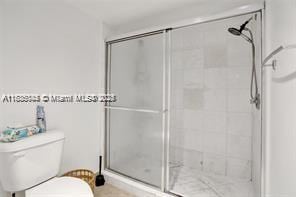 3400 NE 192nd St Unit 1403, Aventura, FL 33180 - full bathroom featuring toilet and a shower stall