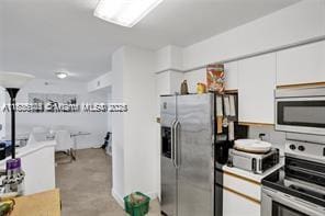 3400 NE 192nd St Unit 1403, Aventura, FL 33180 - kitchen with appliances with stainless steel finishes and white cabinets