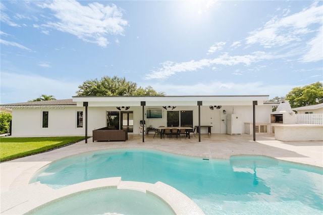 12241 SW 120th Ave, Miami, FL 33186 - back of property with stucco siding, a patio area, an outdoor hangout area, and a pool with connected hot tub