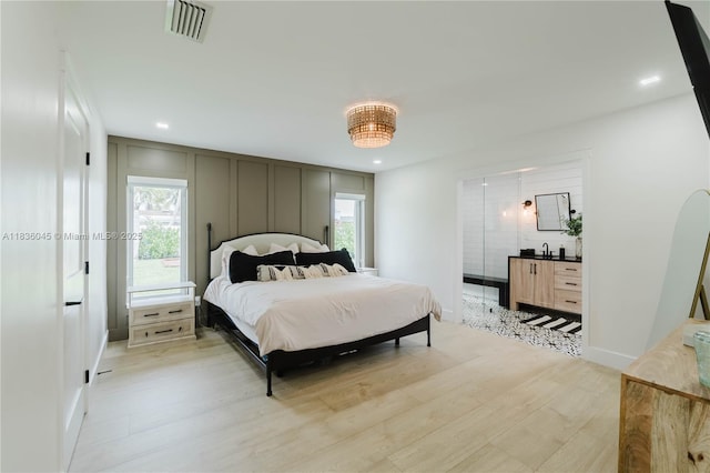 12241 SW 120th Ave, Miami, FL 33186 - bedroom with light wood finished floors, a decorative wall, and recessed lighting