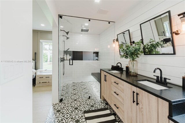 12241 SW 120th Ave, Miami, FL 33186 - ensuite bathroom featuring double vanity, a tile shower, and tile walls
