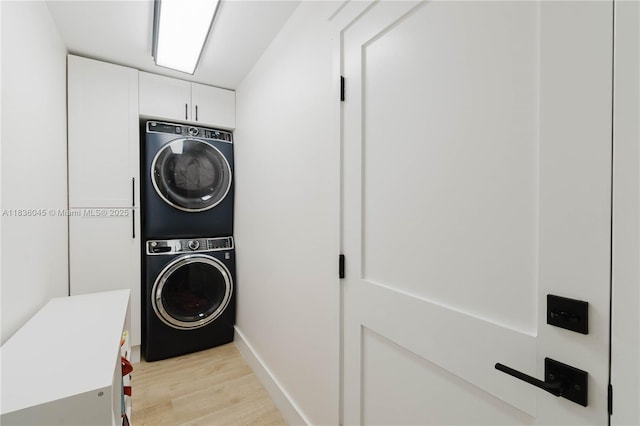 12241 SW 120th Ave, Miami, FL 33186 - laundry room featuring estacked washer and dryer, cabinet space, and light wood finished floors