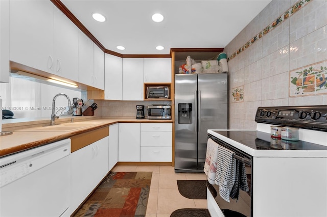 3036 N 58th Ave, Hollywood, FL 33021 - kitchen featuring appliances with stainless steel finishes, decorative backsplash, white cabinets, light countertops, and recessed lighting