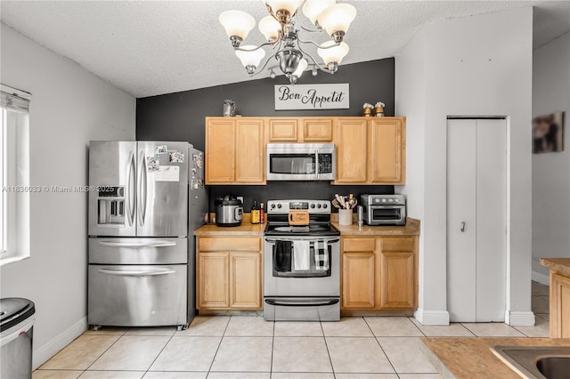 2472 SW 106th Ave, Miramar, FL 33025 - kitchen with appliances with stainless steel finishes, a chandelier, a textured ceiling, light tile patterned floors, and light countertops
