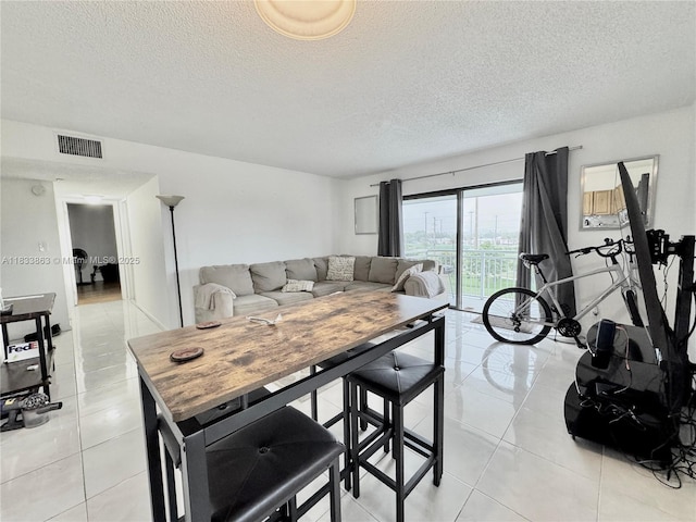 505 S Pine Island Rd Unit 407B, Plantation, FL 33324 - living room with a textured ceiling and light tile patterned floors