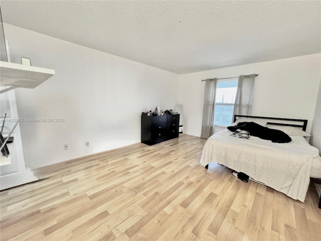 505 S Pine Island Rd Unit 407B, Plantation, FL 33324 - bedroom featuring light wood-style flooring and a textured ceiling