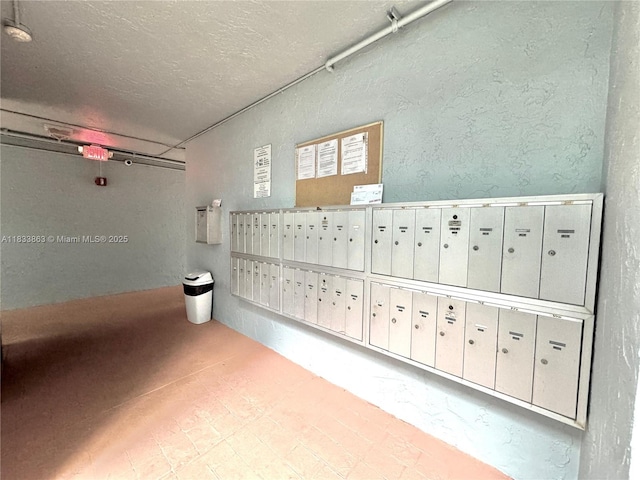 505 S Pine Island Rd Unit 407B, Plantation, FL 33324 - surrounding community featuring mail area, a textured wall, and a textured ceiling