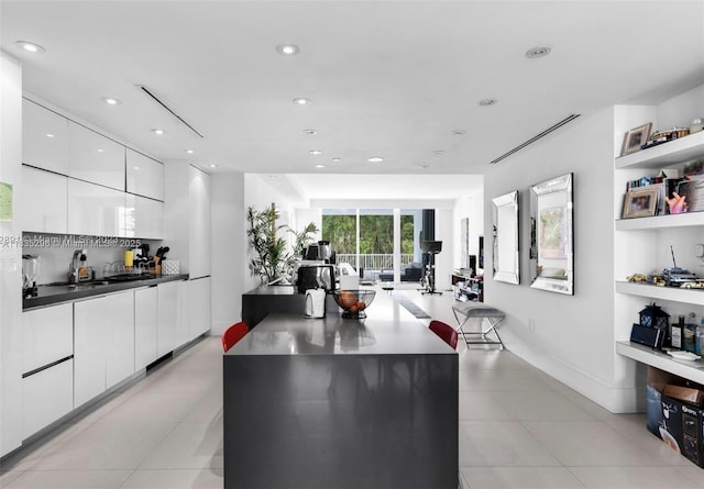 785 Crandon Blvd Unit 302, Key Biscayne, FL 33149 - kitchen with modern cabinets, white cabinets, light tile patterned floors, dark countertops, and recessed lighting