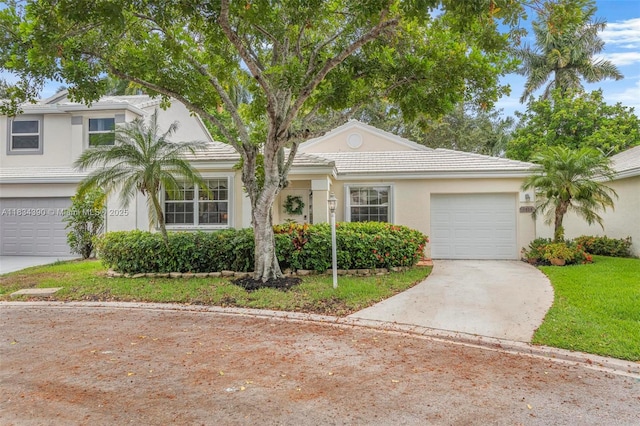 9614 NW 8th Cir, Plantation, FL 33324 - view of front of house featuring driveway, stucco siding, an attached garage, a front yard, and a tile roof