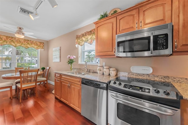 9614 NW 8th Cir, Plantation, FL 33324 - kitchen featuring appliances with stainless steel finishes, rail lighting, wood finished floors, a ceiling fan, and light stone counters