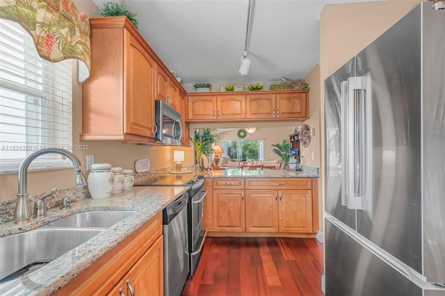 9614 NW 8th Cir, Plantation, FL 33324 - kitchen with stainless steel appliances, dark wood finished floors, light stone countertops, rail lighting, and brown cabinets