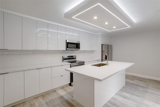 1170 SW 118th Ter, Davie, FL 33325 - kitchen featuring stainless steel appliances, modern cabinets, white cabinets, light wood finished floors, and recessed lighting
