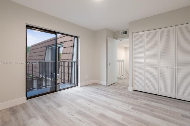 1170 SW 118th Ter, Davie, FL 33325 - unfurnished bedroom with wood finished floors, access to outside, and a closet