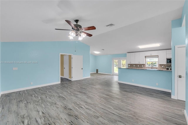 15859 N 68th Ct N, Loxahatchee, FL 33470 - unfurnished living room with a ceiling fan, light wood-type flooring, and vaulted ceiling