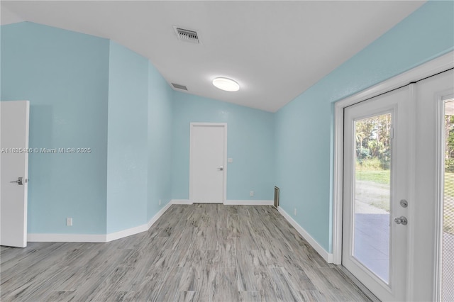 15859 N 68th Ct N, Loxahatchee, FL 33470 - unfurnished room featuring vaulted ceiling and wood finished floors