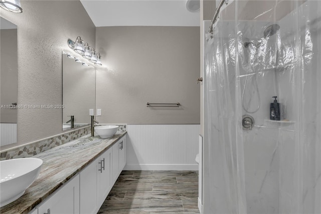 15859 N 68th Ct N, Loxahatchee, FL 33470 - full bathroom with double vanity, curtained shower, and a wainscoted wall
