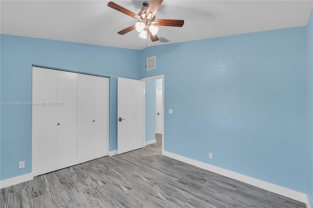 15859 N 68th Ct N, Loxahatchee, FL 33470 - unfurnished bedroom with a closet, wood finished floors, a ceiling fan, and lofted ceiling