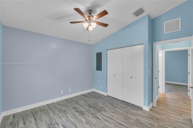 15859 N 68th Ct N, Loxahatchee, FL 33470 - unfurnished bedroom with lofted ceiling, electric panel, light wood-style floors, a closet, and ceiling fan