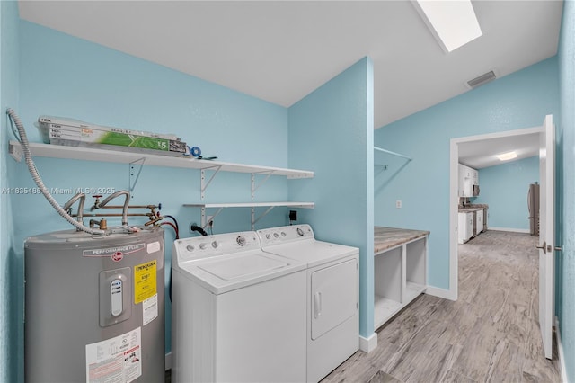 15859 N 68th Ct N, Loxahatchee, FL 33470 - laundry room featuring electric water heater, washer and dryer, light wood-style flooring, and a skylight