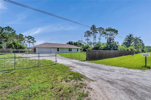 15859 N 68th Ct N, Loxahatchee, FL 33470 - view of front of house with driveway and a garage