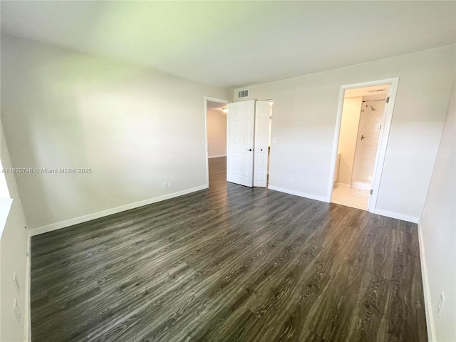 9750 Sunrise Lakes Blvd Unit 109, Sunrise, FL 33322 - unfurnished bedroom with dark wood-style floors and ensuite bathroom