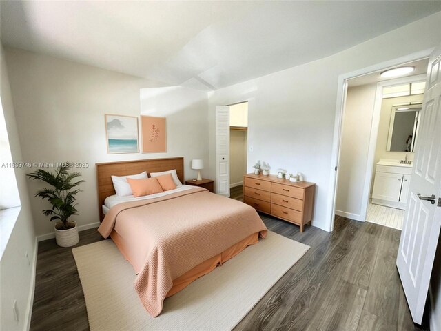 9750 Sunrise Lakes Blvd Unit 109, Sunrise, FL 33322 - bedroom featuring dark wood-style floors and connected bathroom