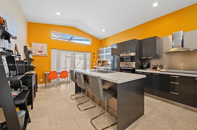 17476 SW 20th St, Miramar, FL 33029 - kitchen featuring wall chimney range hood, stainless steel double oven, black electric cooktop, light countertops, and a breakfast bar area