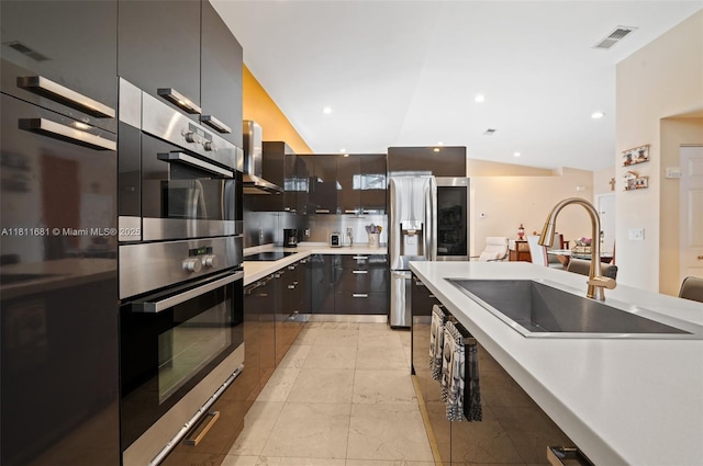 17476 SW 20th St, Miramar, FL 33029 - kitchen featuring stainless steel appliances, modern cabinets, wall chimney exhaust hood, light countertops, and lofted ceiling