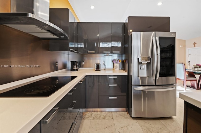 17476 SW 20th St, Miramar, FL 33029 - kitchen featuring stainless steel fridge with ice dispenser, wall chimney exhaust hood, black electric stovetop, light countertops, and modern cabinets