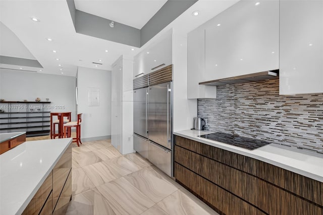 18201 Collins Ave Unit Ts2 & Ts3, Sunny Isles Beach, FL 33160 - kitchen with modern cabinets, black electric cooktop, white cabinetry, built in fridge, and backsplash