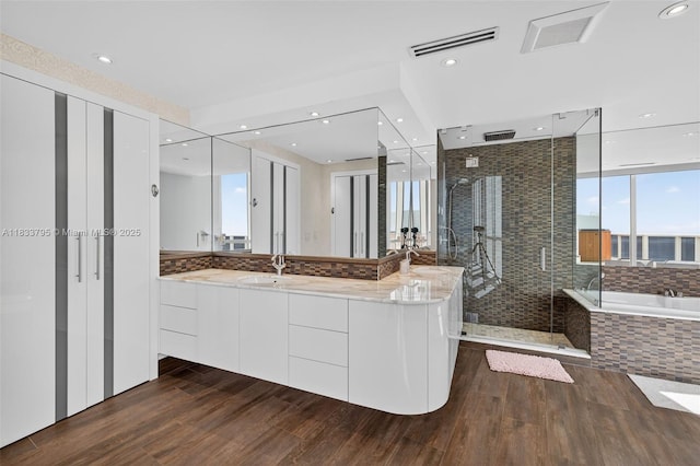 18201 Collins Ave Unit Ts2 & Ts3, Sunny Isles Beach, FL 33160 - bathroom with a garden tub, wood finished floors, a stall shower, and recessed lighting
