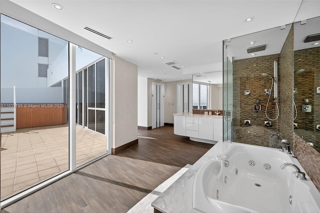 18201 Collins Ave Unit Ts2 & Ts3, Sunny Isles Beach, FL 33160 - full bath featuring wood finished floors, vanity, a stall shower, a tub with jets, and recessed lighting