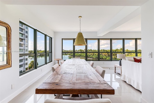 9102 W Bay Harbor Dr Unit 5-D, Bay Harbor Islands, FL 33154 - dining room featuring light tile patterned floors, a water view, and beamed ceiling