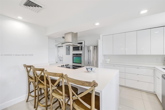 9102 W Bay Harbor Dr Unit 5-D, Bay Harbor Islands, FL 33154 - kitchen featuring modern cabinets, appliances with stainless steel finishes, a breakfast bar area, and white cabinets