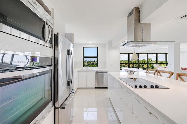 9102 W Bay Harbor Dr Unit 5-D, Bay Harbor Islands, FL 33154 - kitchen with stainless steel appliances, light countertops, white cabinetry, and light tile patterned flooring