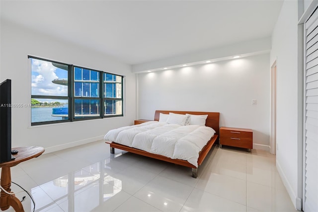 9102 W Bay Harbor Dr Unit 5-D, Bay Harbor Islands, FL 33154 - bedroom with baseboards and light tile patterned floors