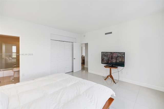 9102 W Bay Harbor Dr Unit 5-D, Bay Harbor Islands, FL 33154 - bedroom featuring a closet and tile patterned floors