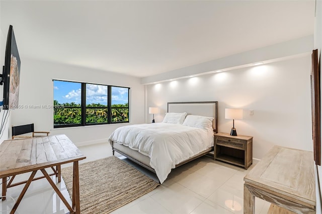 9102 W Bay Harbor Dr Unit 5-D, Bay Harbor Islands, FL 33154 - bedroom featuring light tile patterned floors and baseboards
