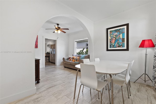 2946 SW 26th St, Miami, FL 33133 - dining space with arched walkways, ceiling fan, and crown molding