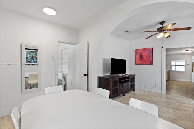2946 SW 26th St, Miami, FL 33133 - bedroom featuring arched walkways, crown molding, wood finished floors, and a ceiling fan